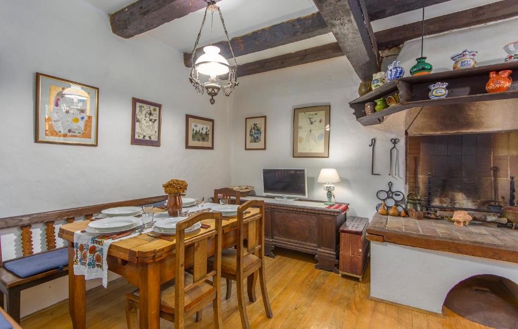 a dining room with a table and a fireplace at Apartment Kuharić in Grožnjan