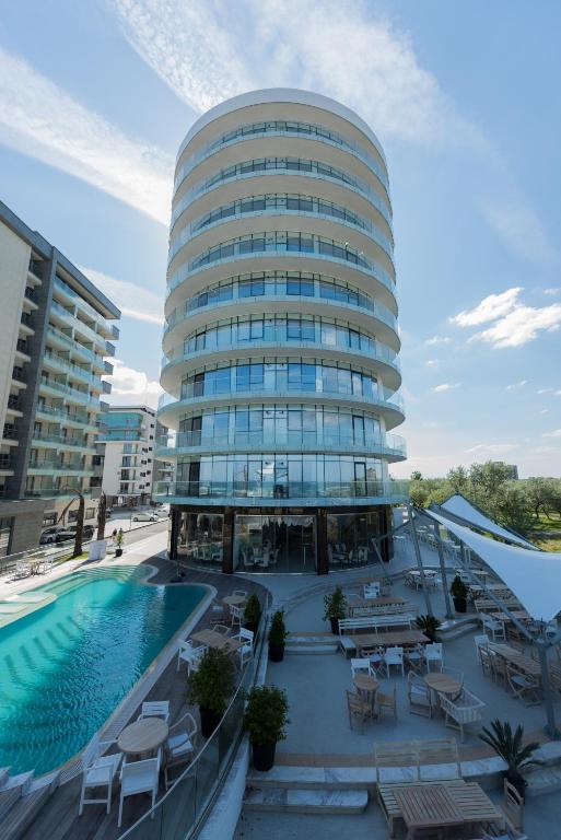 a large building with a swimming pool in front of it at White Tower Mamaia in Mamaia