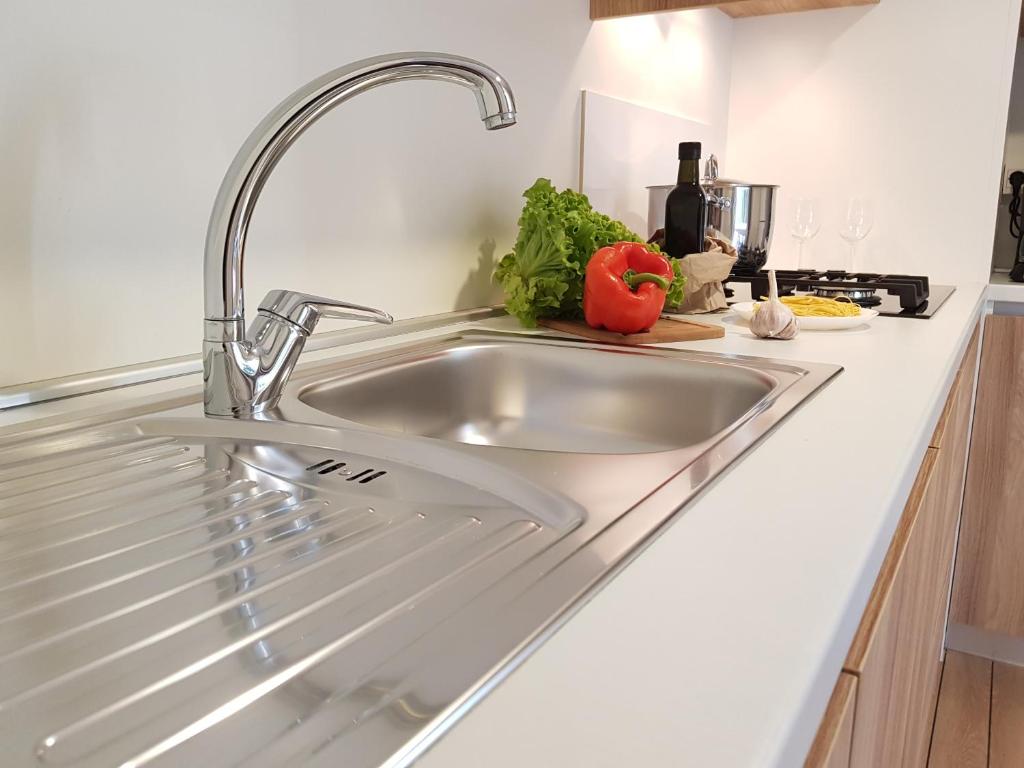 a kitchen sink with a faucet on a counter at Mobile Homes Banko in Bijela Uvala and Zelena laguna in Poreč