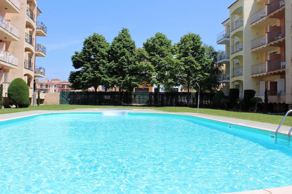 a large swimming pool in front of a building at Marina Beach Hollidays Mimosa in Empuriabrava