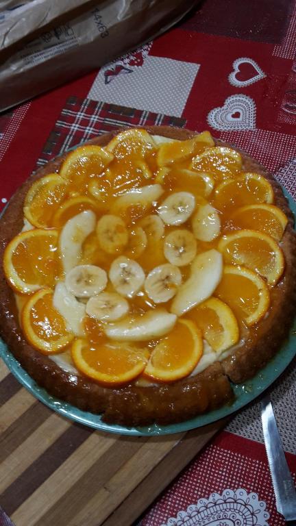 a cake with bananas and oranges on a table at Villa Salvatore in San Leone