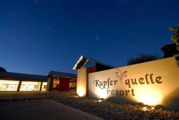 a building with a sign that reads kiger cubic resort at Kupferquelle Resort in Tsumeb