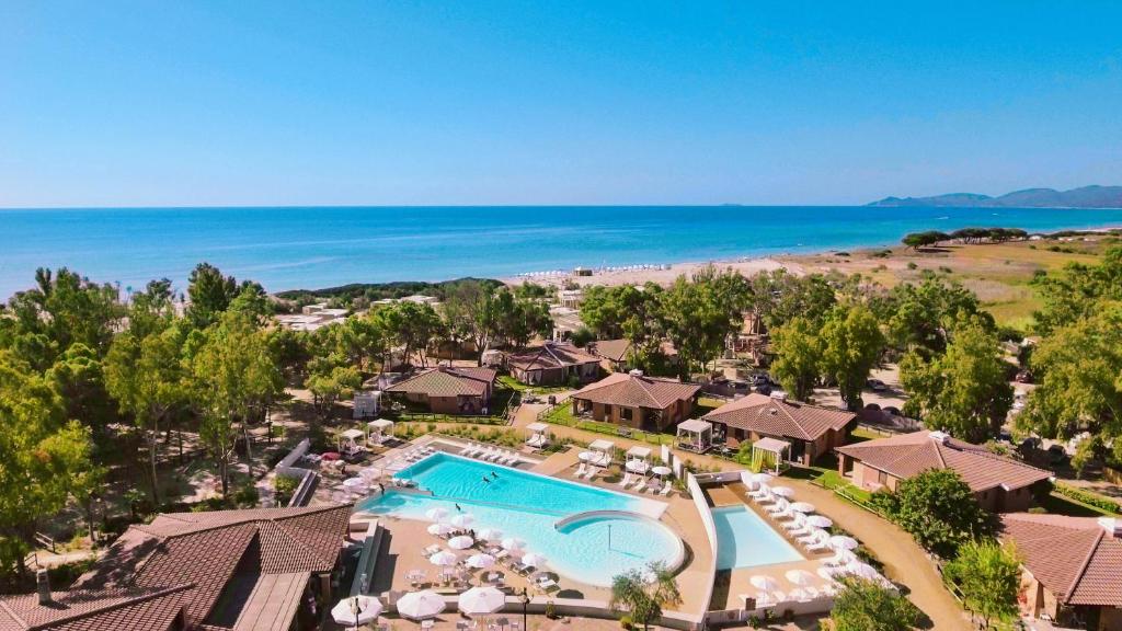 an aerial view of a resort with a swimming pool and the beach at Tiliguerta Glamping&Camping Village in Costa Rei