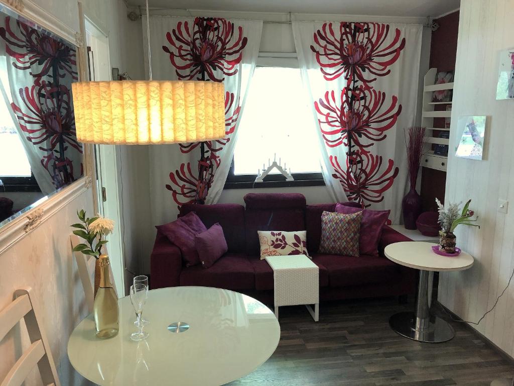 a living room with a couch and a table at Raita House in Savonlinna