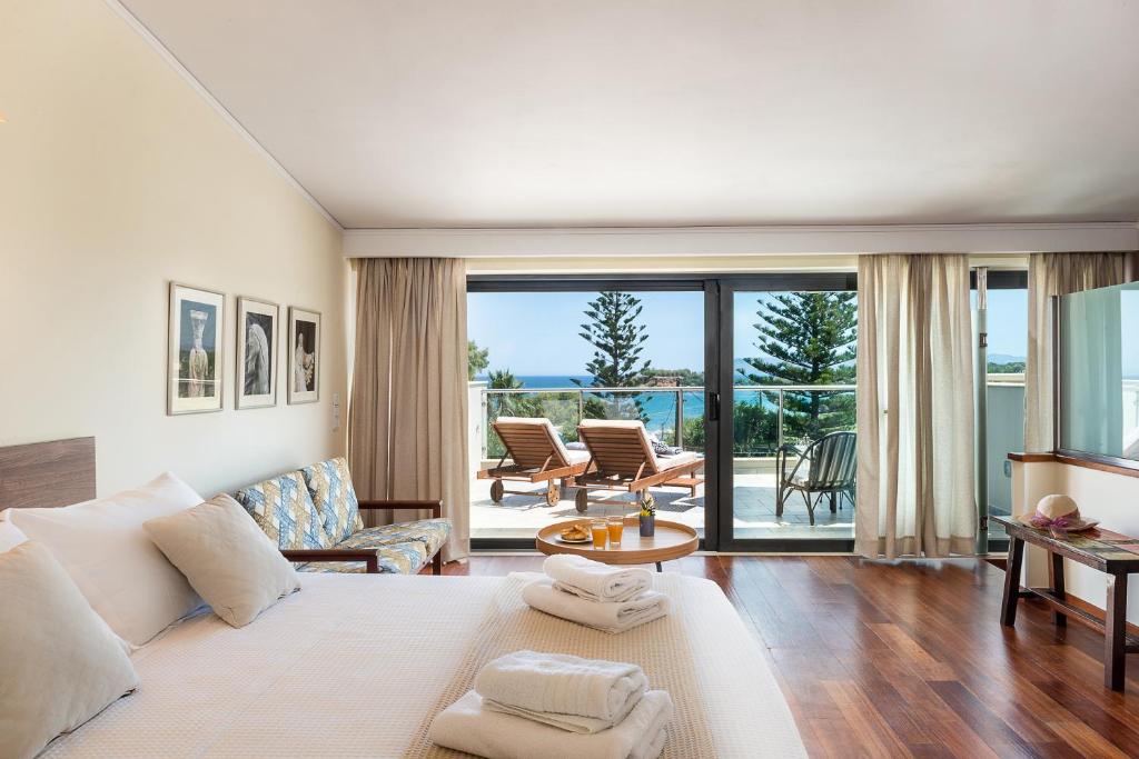 a living room with a white couch and a table at Villa Ismini in Kato Daratso