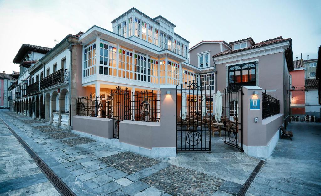 a building with a gate on a city street at Hotel Rey Silo in Pravia