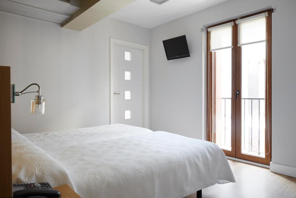 Postel nebo postele na pokoji v ubytování Hotel Olatu