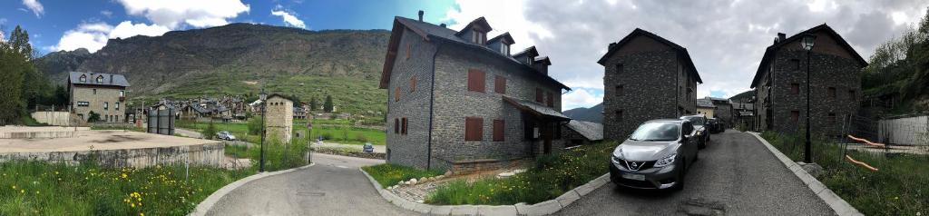 a car parked in front of a building on a road at Le petit Espot in Espot