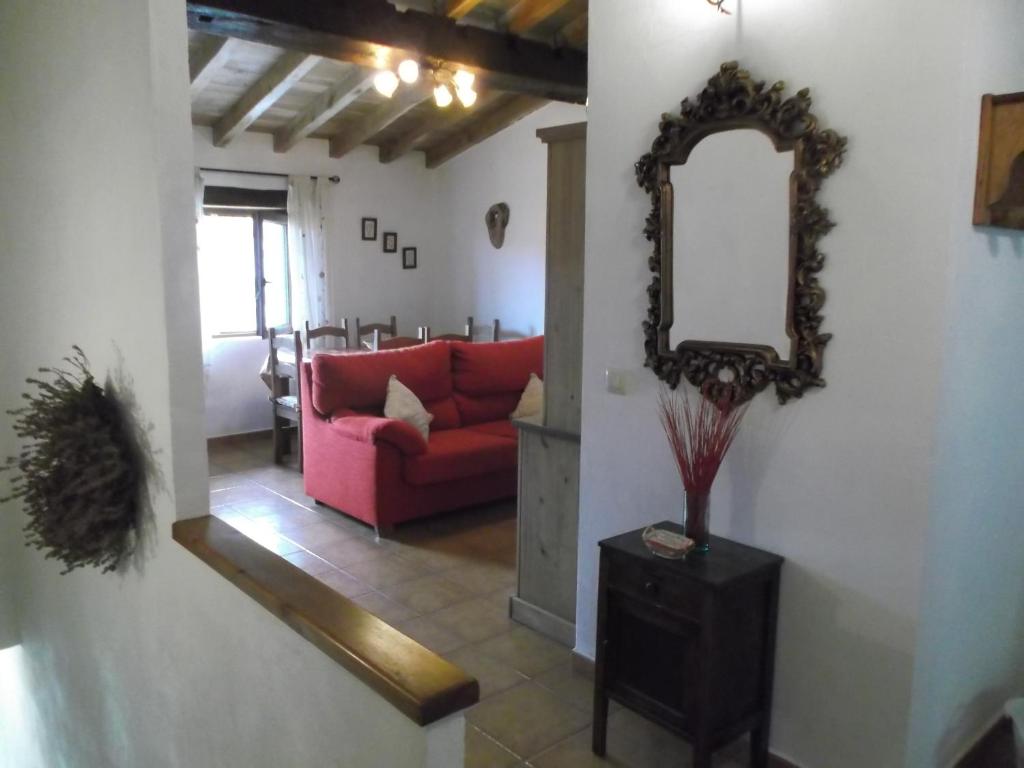 a living room with a red couch and a mirror at Apartamento San Mamés in San Mamés