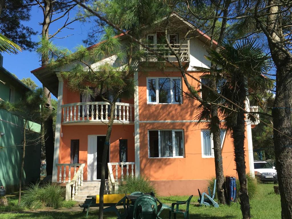 an orange house with a balcony on top of it at Villa Shekvetili in Shekhvetili