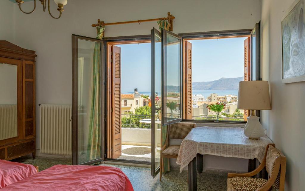 a room with a bed and a table and a window at Holiday Home Froudaki 1 in Kissamos