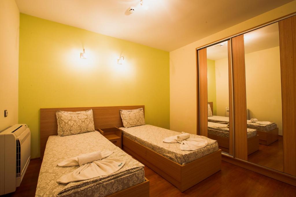 A bed or beds in a room at Aparthotel Marina Holiday Club - All Inclusive & Free Parking