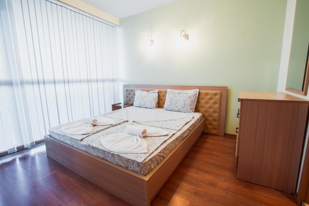 A bed or beds in a room at Aparthotel Marina Holiday Club - All Inclusive & Free Parking