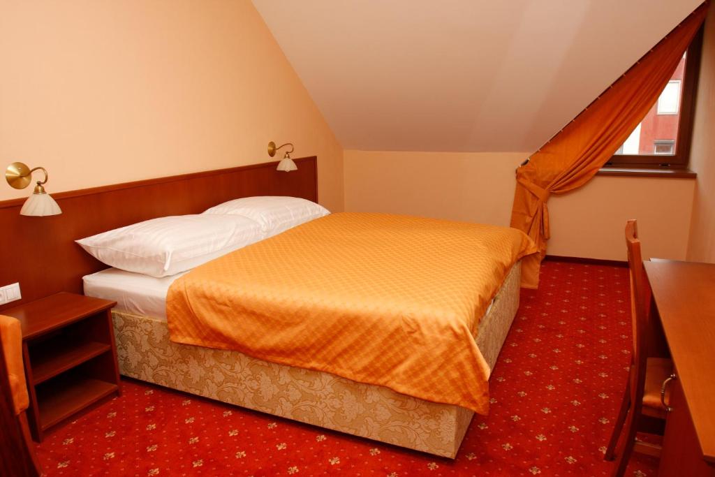 Posteľ alebo postele v izbe v ubytovaní Hotel Majolika