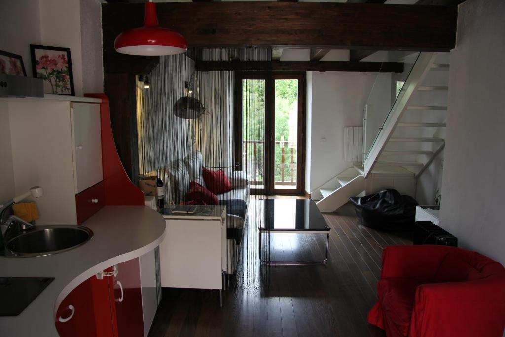 a kitchen with a sink and a red couch at Lucanus Cervus in Rascafría