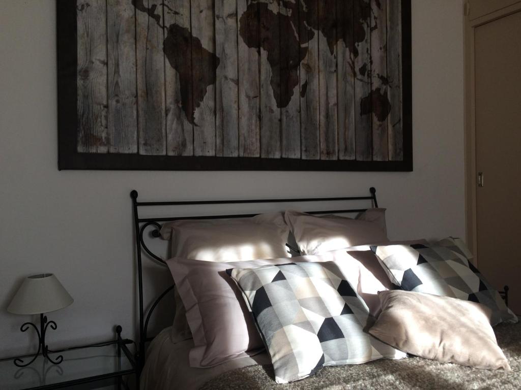 ein Schlafzimmer mit einem Bett mit einer Karte an der Wand in der Unterkunft La Maison de Valentine in Jarjayes
