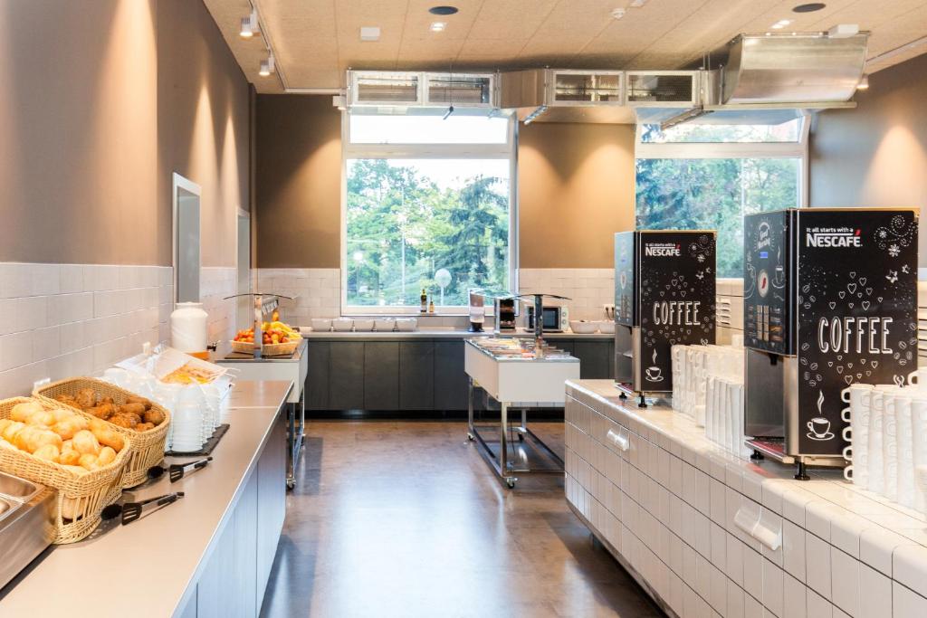 a large kitchen with aasteryasteryasteryasteryasteryasteryasteryasteryasteryasteryastery at a&o Prague Rhea in Prague