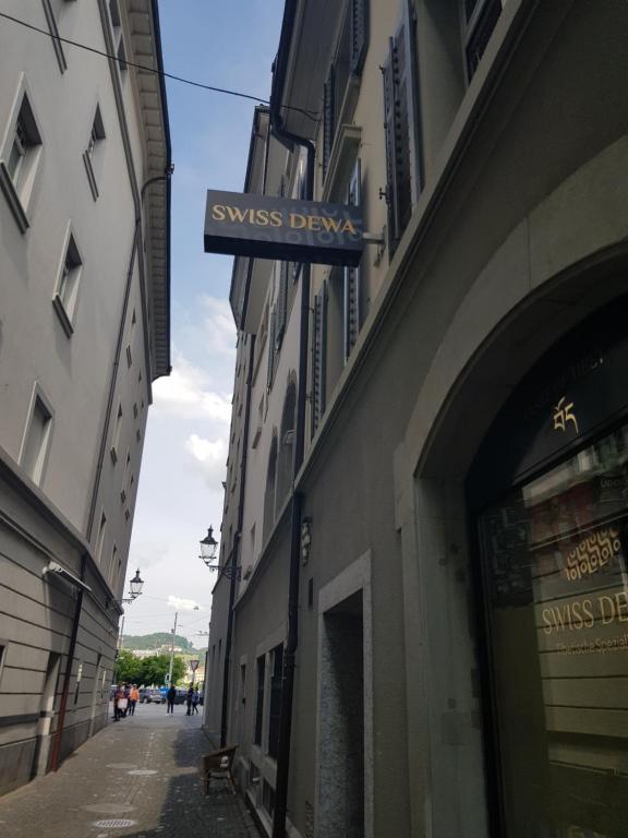 a street with a sign on the side of a building at Swiss Dewa in Lucerne