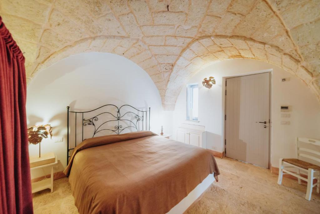 A bed or beds in a room at Masseria Ancella