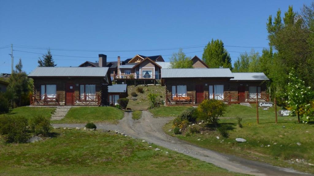 a large house with a road in front of it at Cabañas Bahía Marina in El Calafate