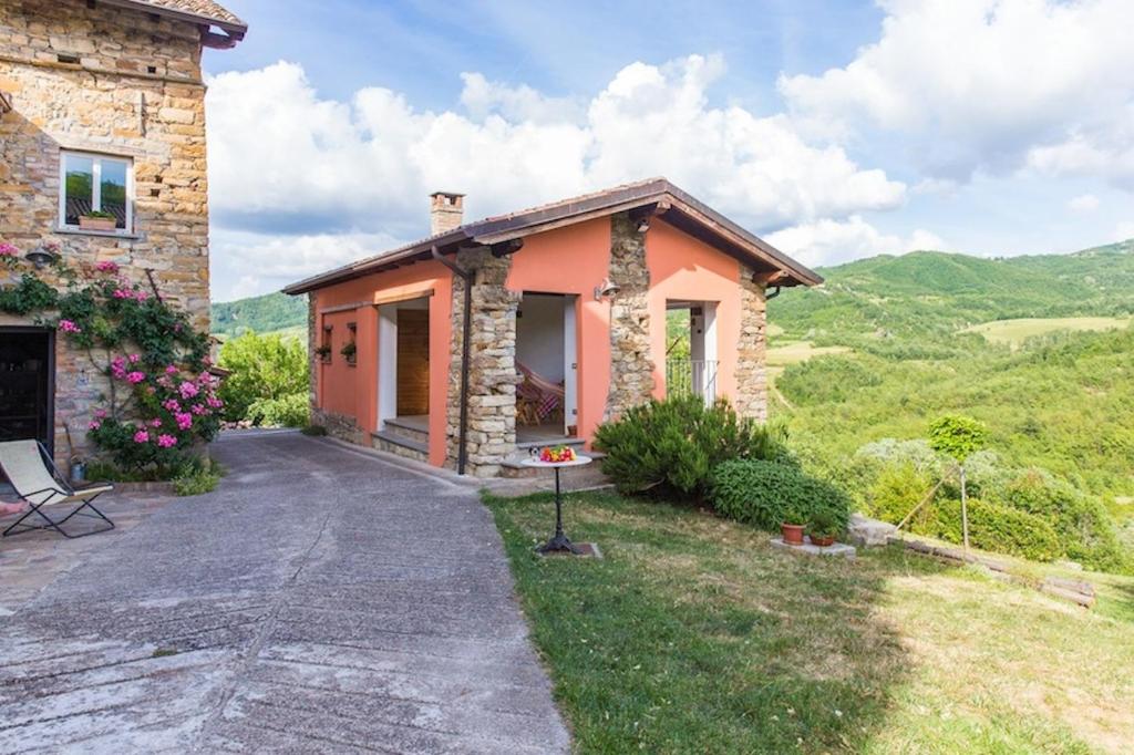 a stone house with a view of the mountains at nido d'amore in Dernice