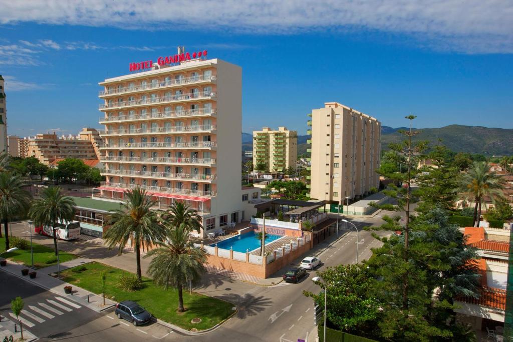 
a large building with a lot of palm trees at Gandia Playa in Gandía
