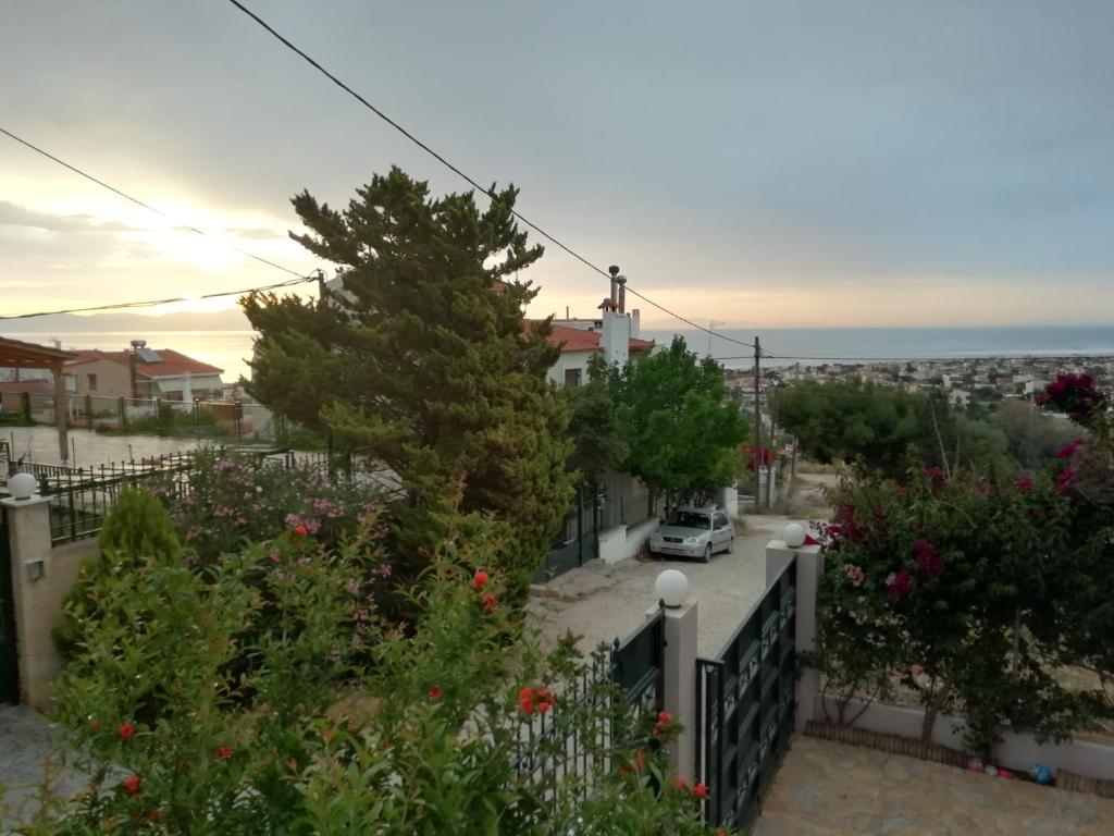 a view from the balcony of a house with flowers at Airport Family House in Artemida