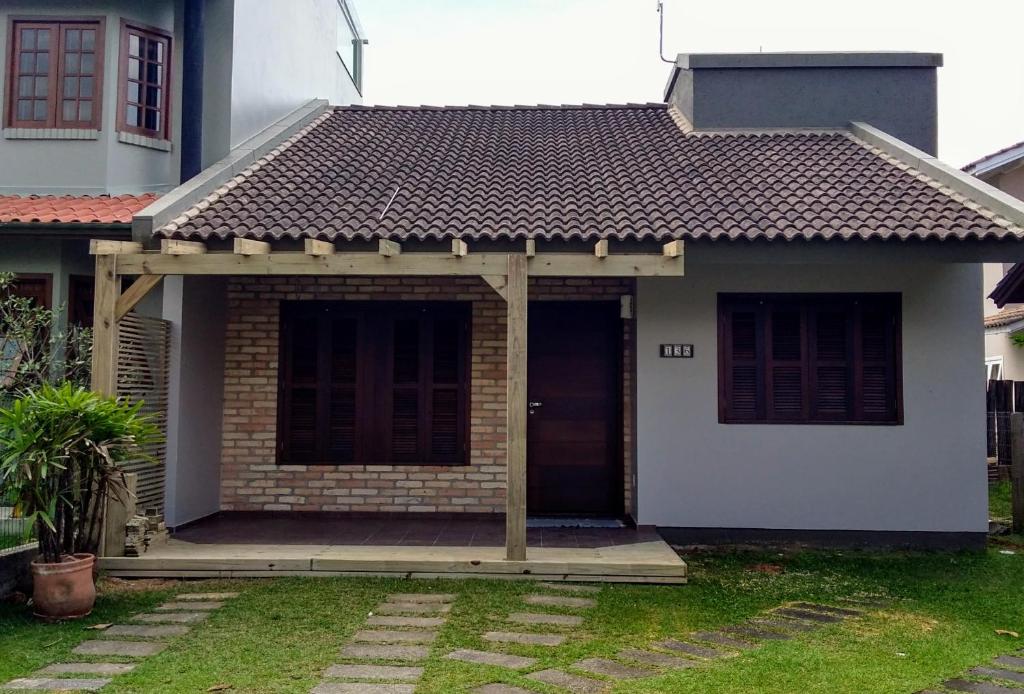 a small brick house with a roof at Casa Caribe in Garopaba