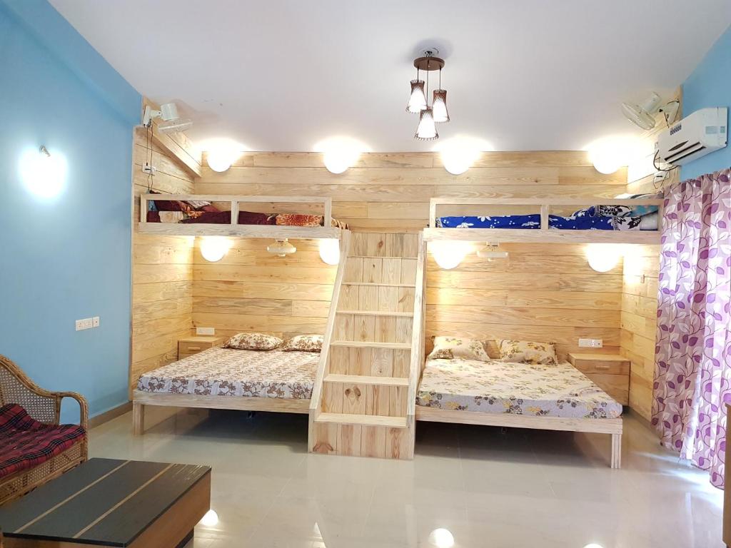 a bedroom with two bunk beds and a ladder at Godwill Casa Varca in Varca