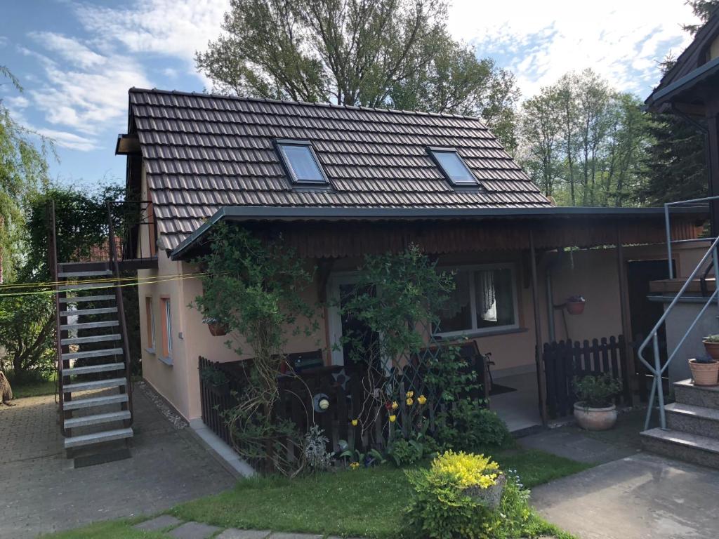a small house with a staircase leading up to it at Peeneurlaub in Lassan