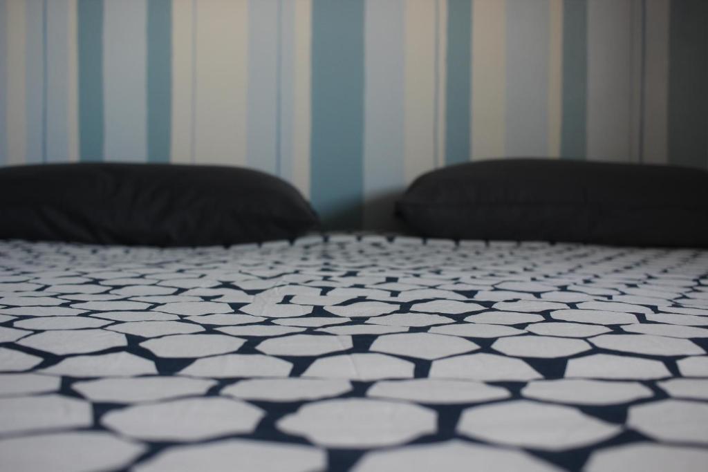 ヴェノーザにあるB&B Al Gravattoneのベッドルーム1室(白黒のベッド1台、枕2つ付)