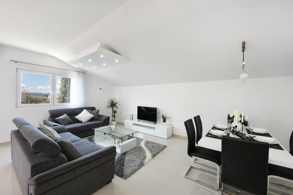 a living room with a couch and a table at Apartment Monika - Private terrace & Parking in Zadar
