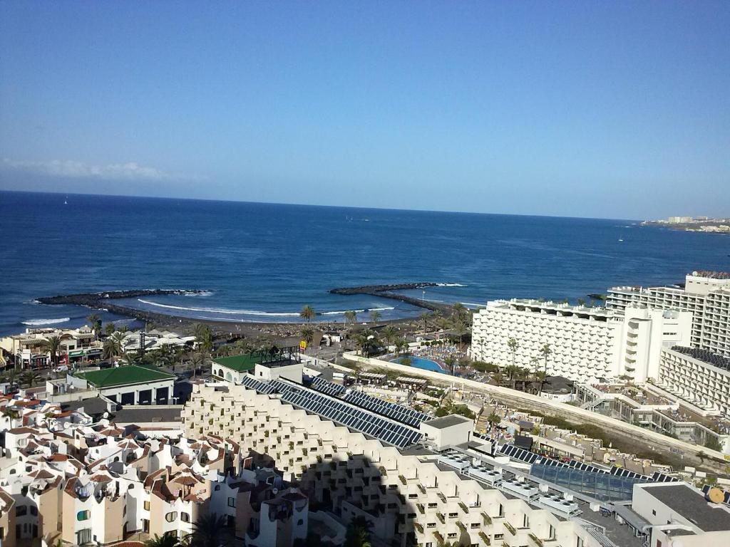 an aerial view of a beach with buildings and the ocean at Apartamento Playa las Americas in Playa de las Americas