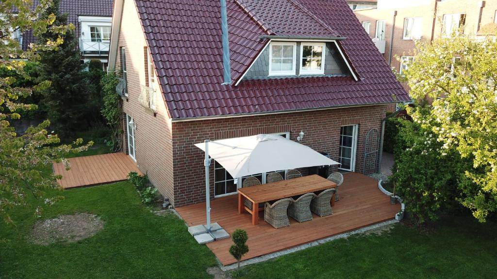 an overhead view of a deck with a table and a white umbrella at Neptun17 in Scharbeutz
