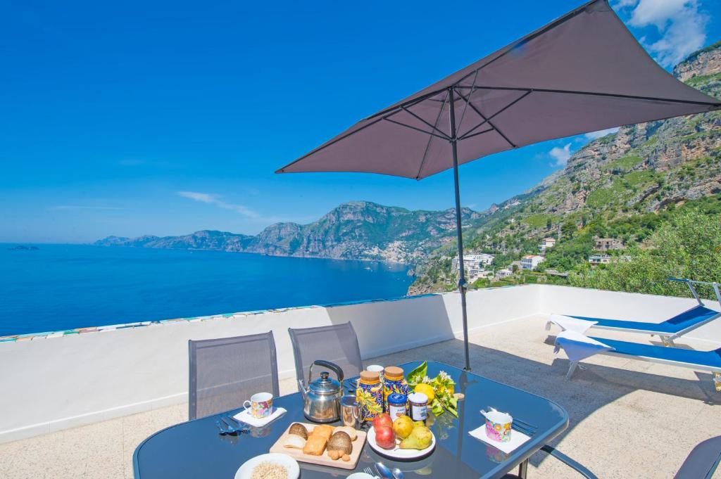 a table with food on it with a view of the ocean at My Shazzy with amazing Sea View terrace in Praiano