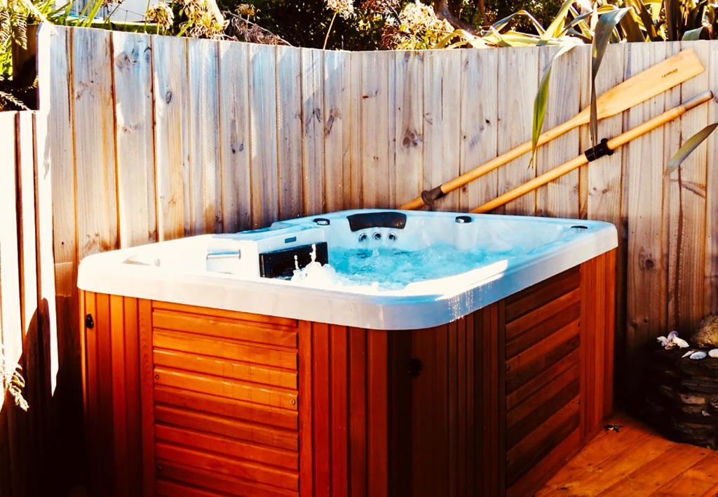 a bath tub sitting in front of a wooden fence at Rock Lobster in Southport