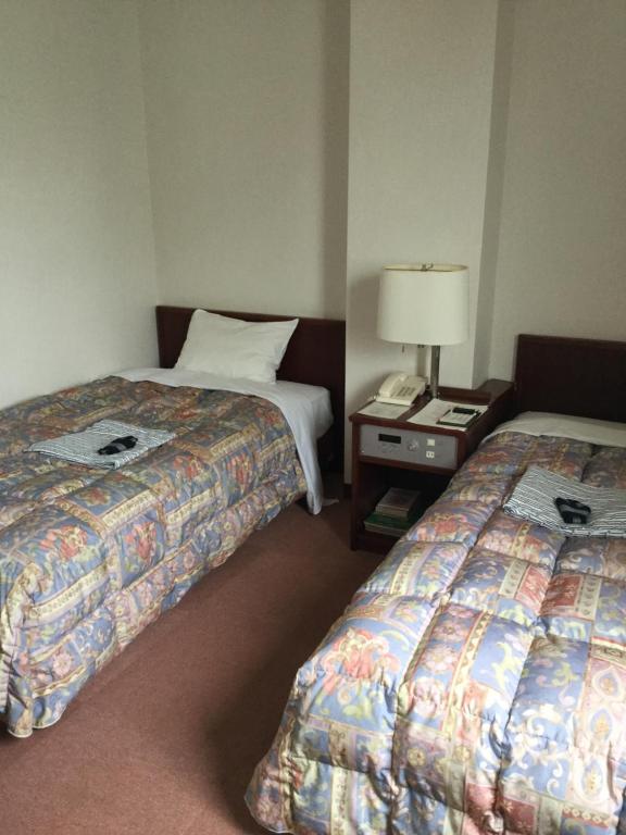 Postel nebo postele na pokoji v ubytování Hotel kakuban