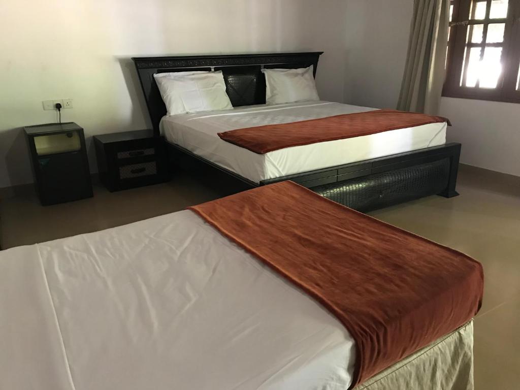 Postel nebo postele na pokoji v ubytování Hotel 4 U Saliya Garden