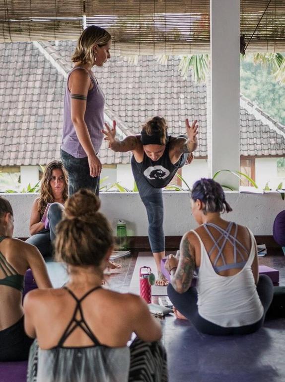 a group of women sitting on the floor in a yoga class at Ecosfera Hotel & Spa in Canggu