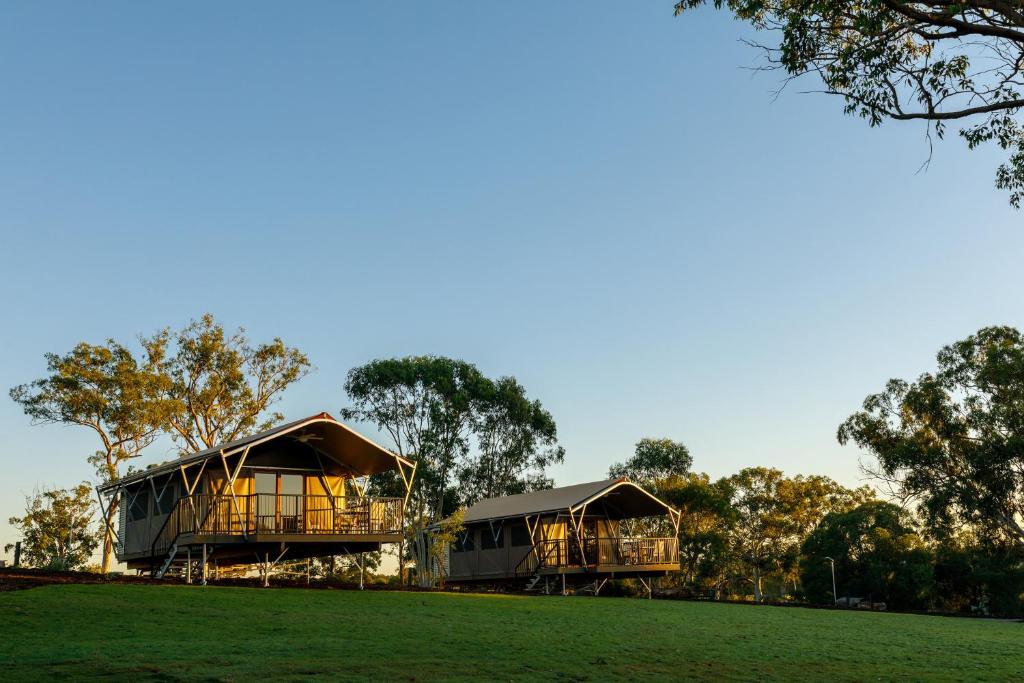 a large wooden house with a tree in front of it at Sanctuary by Sirromet in Mount Cotton