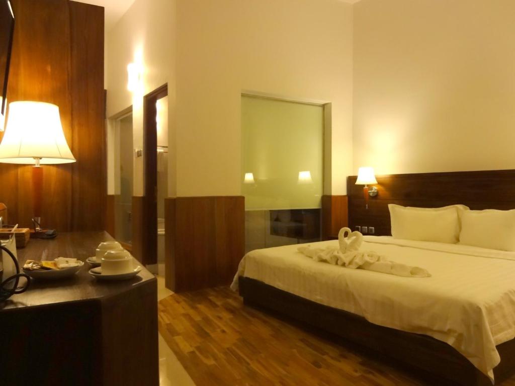 Postel nebo postele na pokoji v ubytování Taman Simalem Resort