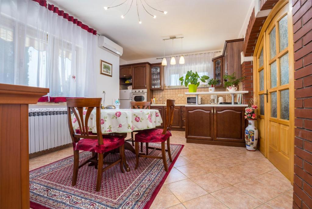 Apartments Janko في روفينج: مطبخ مع طاولة وكراسي في غرفة