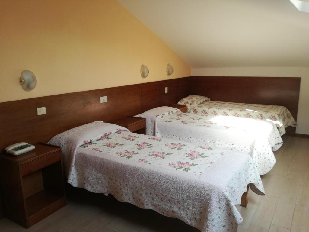 Postel nebo postele na pokoji v ubytování Hotel Prati