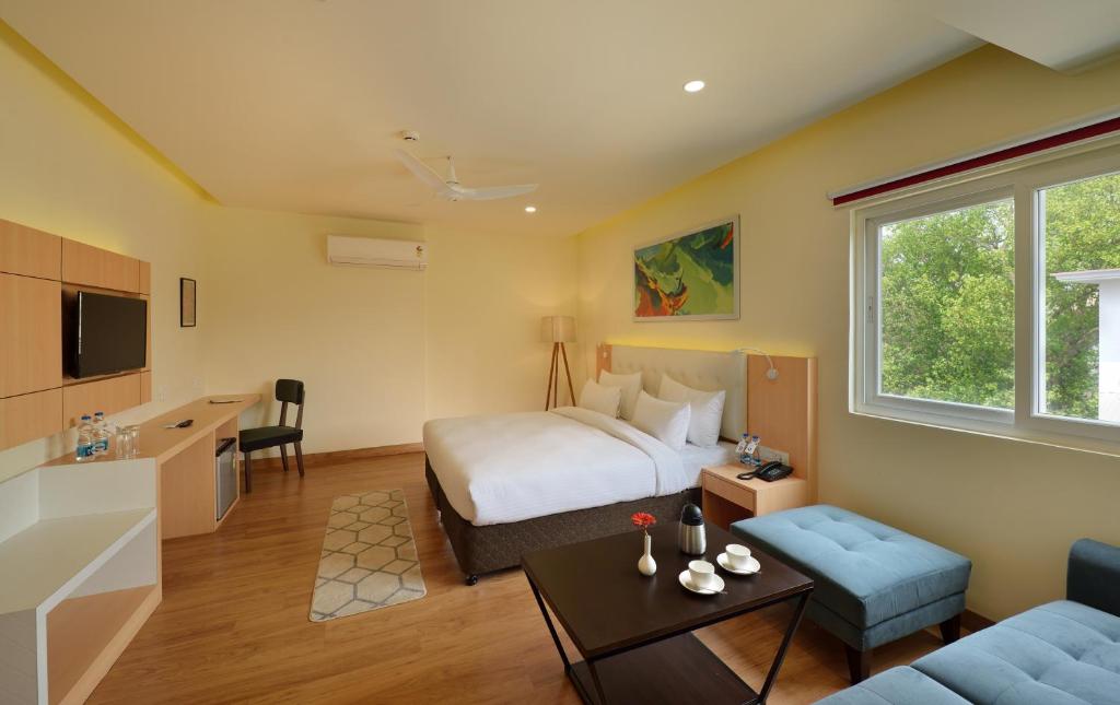 a hotel room with a bed and a couch at 10 Park Street Bed & Breakfast in Gorakhpur