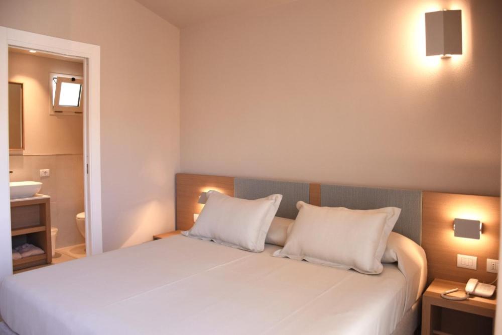 Postel nebo postele na pokoji v ubytování Domu Simius Life Style Hotel