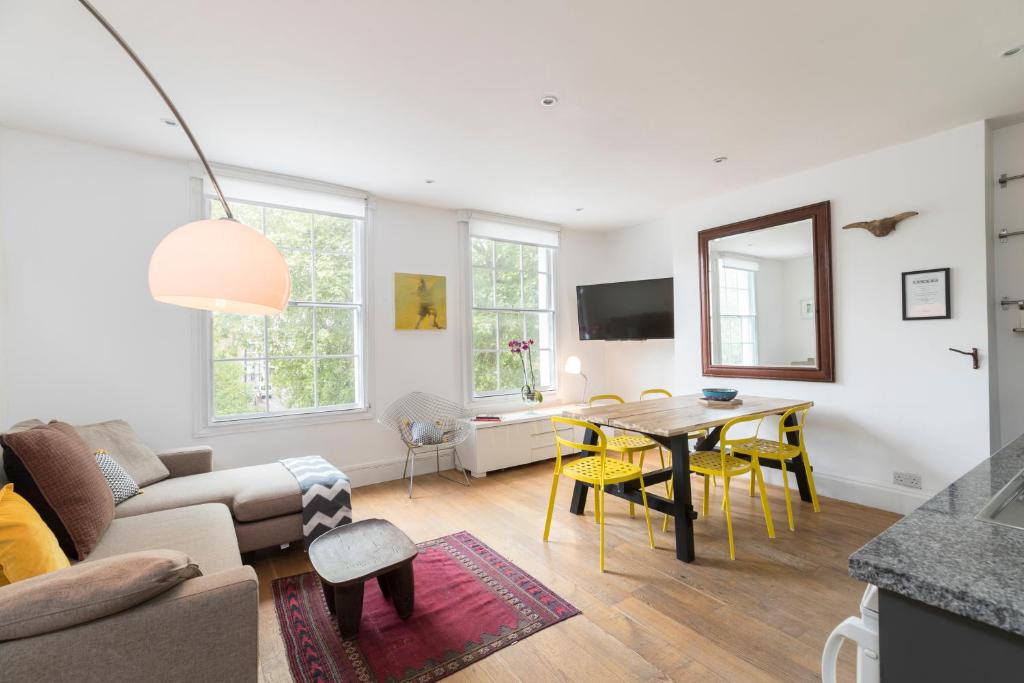 a living room with a couch and a table at ALTIDO Spacious & Chic flat in Angel in London