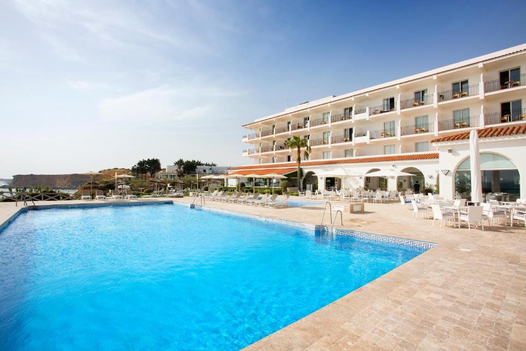 a swimming pool in front of a hotel at Hipotels Flamenco Conil in Conil de la Frontera