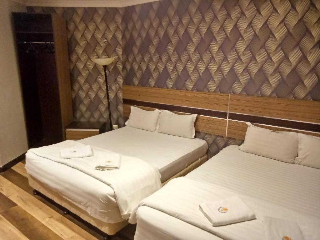 Posteľ alebo postele v izbe v ubytovaní Sai Villa Hotel Near Klia & Klia2