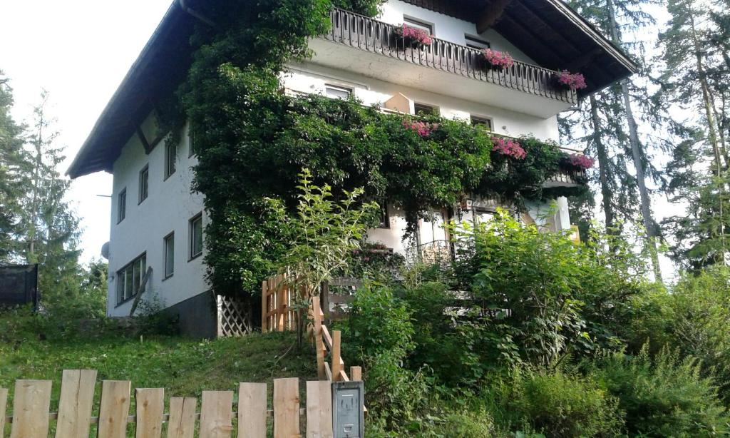 a white house with plants on the side of it at Pension Adlerhorst in Ramsau am Dachstein