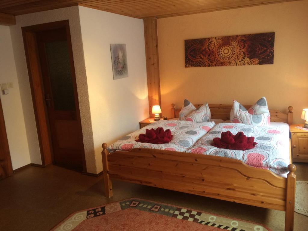 1 dormitorio con 1 cama con 2 almohadas rojas en Ferienwohnung Dietlinde, en Bad Blankenburg